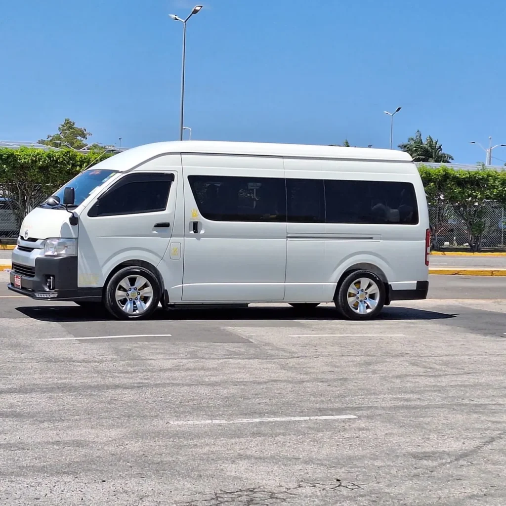 Side view of the white TedTours Toyota Hiace passenger van