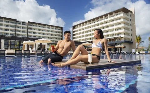 Guests relaxing in a pool at Royalton Blue Waters