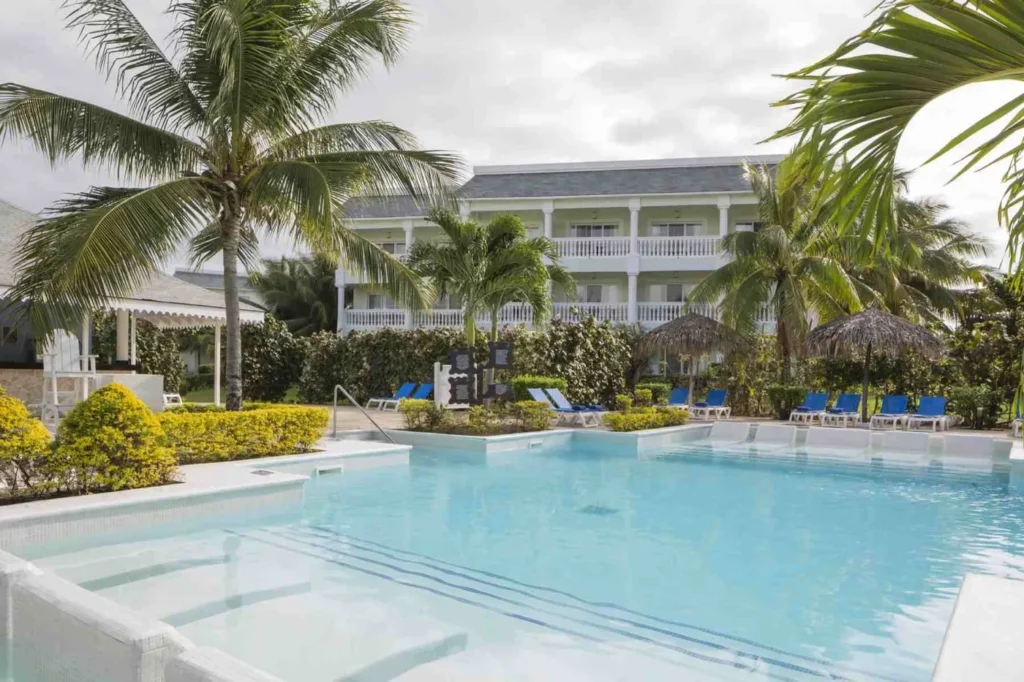 Grand Palladium resort pool surrounded by palms and accommodation buildings